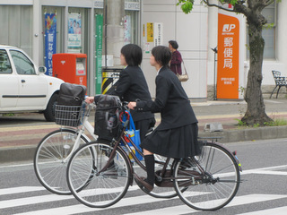Schoolgirls cycling home, Ise