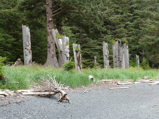 Mortuary poles and beach, S’Gang Waay