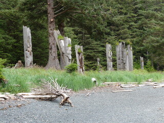 Mortuary poles and beach, S’Gang Waay